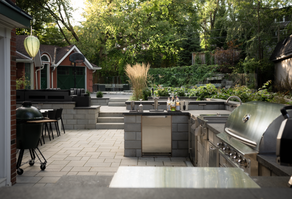 Outdoor Kitchen with BBQ, beer tap, sink, and bar fridge. 